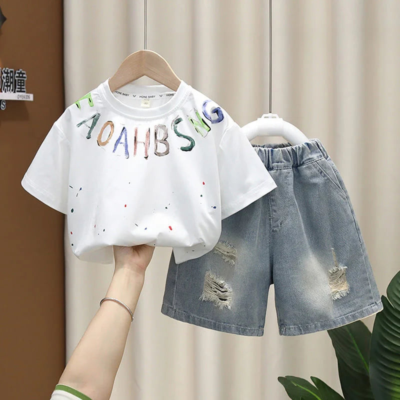Conjunto de Verano para Niños 2026, Camiseta de Algodón con Estampado de Dibujos Animados y Letras + Pantalones Cortos de Mezclilla, Ropa Infantil