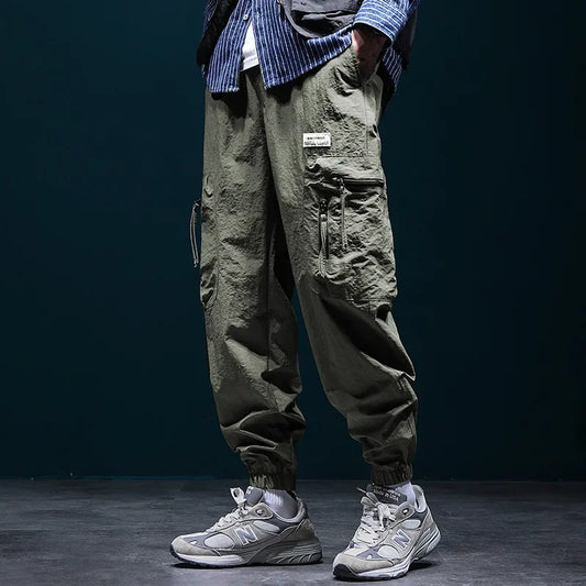Nuevos pantalones Cargo Vintage con múltiples bolsillos para hombre, ropa de calle informal Y2K para exteriores, pantalones de chándal, pantalones de chándal de pierna ancha