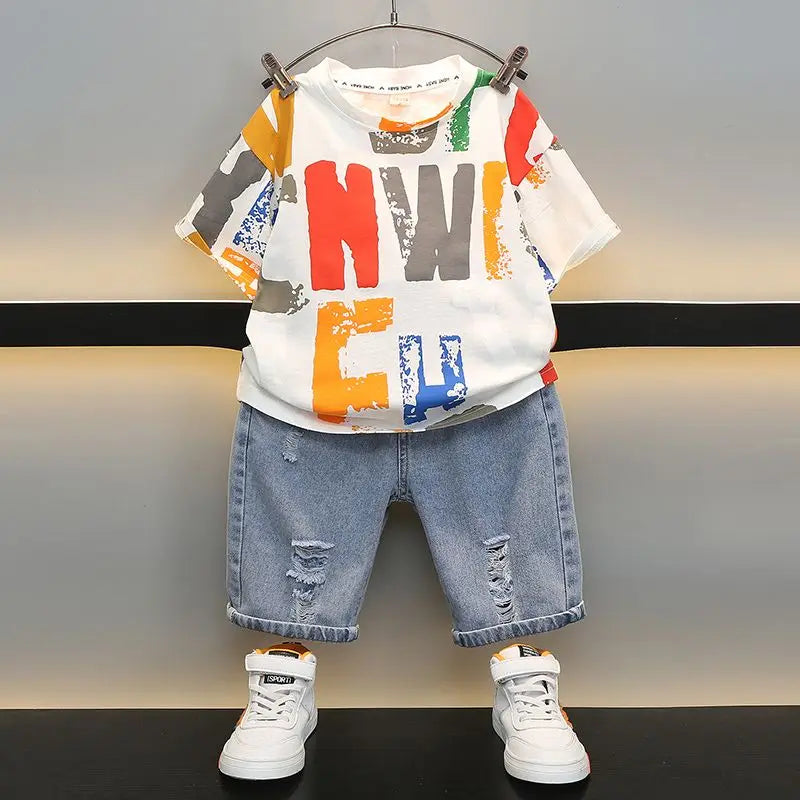 Conjunto de Verano para Niños 2026, Camiseta de Algodón con Estampado de Dibujos Animados y Letras + Pantalones Cortos de Mezclilla, Ropa Infantil